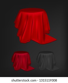 Round table with red and black tablecloth.