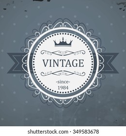 Round vintage label with ribbon, royal crown and grunge background. Vector illustration.