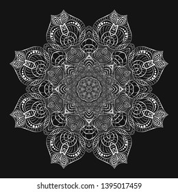 Round white crocheted lace doily. Decorative mandala. Plant and wavy natural elements. The stylization of the sun