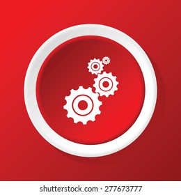 Round white icon with image of gears, on red background