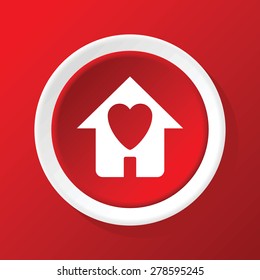 Round white icon with image of house with heart, on red background