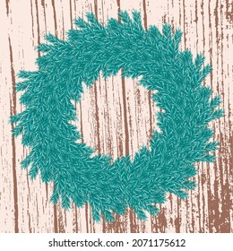 Round wreath of evergreens on wooden background. Decor for the door for the New Year and Christmas holidays. Spruce green wreath on brown wooden background.
