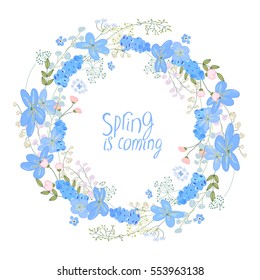 Round wreath made of blue primroses - muscari and hepatica. Template for spring greeting cards