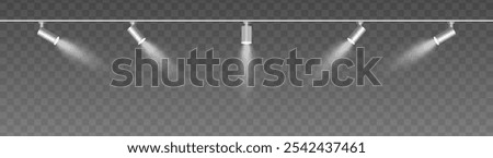 Row of adjustable spotlights with warm white glow, casting angled beams. Modern lighting setup suitable for stage, exhibition, or interior decor, adding ambiance against a dark background