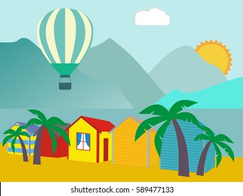 A row of beach huts against blue sky and sand and sea.