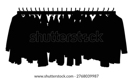 A row of coats hangs on a rack creating a stark black silhouette