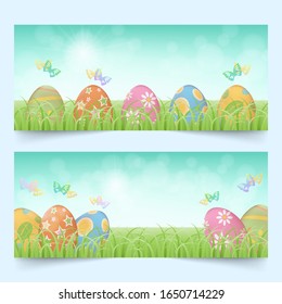 Row of colorful easter eggs behind green grass in a field with butterflies and bright blue sky banners set