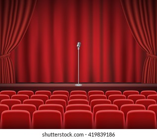 Rows of red cinema or theater seats in front of show stage with retro microphone