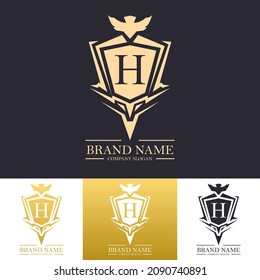 Royal style luxury vector letter h logo design template with gold color and firm shield concept. Decorative gold textured logo. Best for company and premium product.