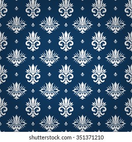 Royal style seamless pattern with classic white styled floral ornament elements on royal blue shaded background. Excellent textile, fabric, paper design.