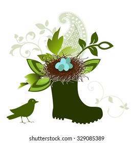 Rubber boot stuffed with bird's next and graphic design elements including paisley 