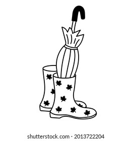 Botas de goma con paraguas plegados.