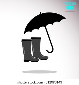 Rubber boots and umbrella