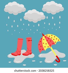 Rubber boots and an umbrella in the rain in a puddle. Template banner of rainy weather. 