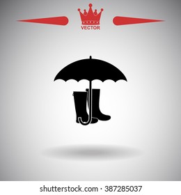 Rubber boots and umbrella vector icon.