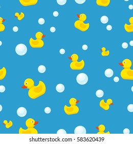 Rubber duck and bubbles seamless pattern bath toy on blue background. Vector illustration