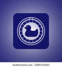 rubber duck icon inside badge with denim texture. 