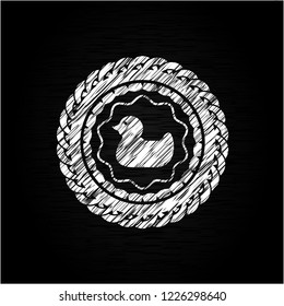 rubber duck icon inside chalkboard emblem on black board