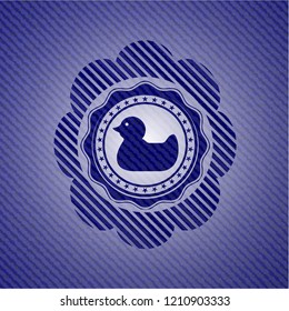 rubber duck icon inside emblem with denim high quality background