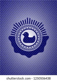 rubber duck icon inside emblem with denim high quality background