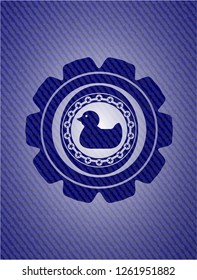 rubber duck icon inside emblem with denim texture
