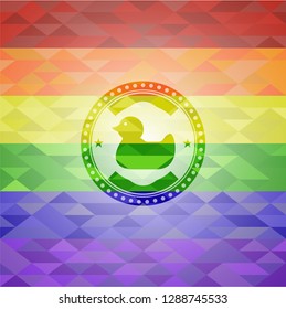 rubber duck icon inside emblem on mosaic background with the colors of the LGBT flag
