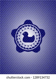 rubber duck icon inside emblem with jean high quality background