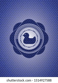 rubber duck icon inside emblem with jean background