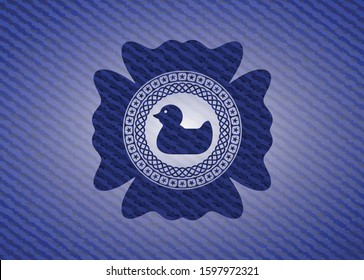 rubber duck icon inside emblem with denim high quality background