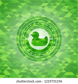 rubber duck icon inside green emblem with triangle mosaic background