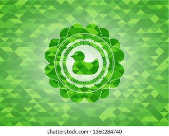 rubber duck icon inside green emblem with mosaic background