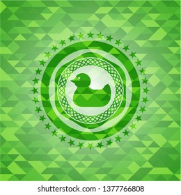 rubber duck icon inside green emblem with triangle mosaic background