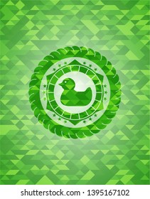 rubber duck icon inside green emblem with mosaic background