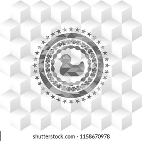 rubber duck icon inside grey badge with geometric cube white background