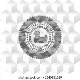 rubber duck icon inside grey emblem with geometric cube white background