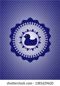 rubber duck icon inside jean or denim emblem or badge background