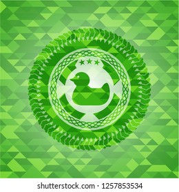 rubber duck icon inside realistic green emblem. Mosaic background