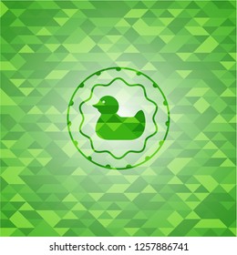 rubber duck icon inside realistic green emblem. Mosaic background