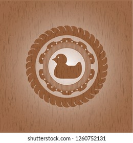 rubber duck icon inside realistic wood emblem