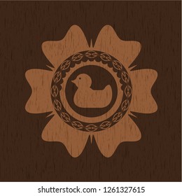 rubber duck icon inside realistic wood emblem