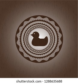 rubber duck icon inside realistic wood emblem
