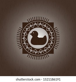 rubber duck icon inside realistic wooden emblem