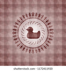 rubber duck icon inside red seamless emblem with geometric pattern background.