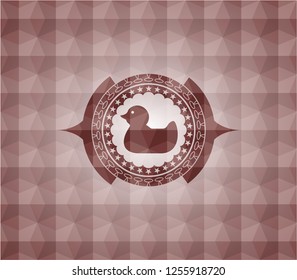 rubber duck icon inside red seamless emblem with geometric pattern background.