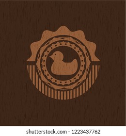 rubber duck icon inside retro wood emblem