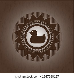 rubber duck icon inside retro style wooden emblem