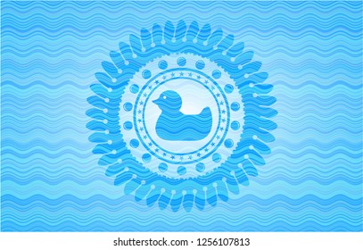 rubber duck icon inside sky blue water wave badge.
