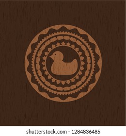 rubber duck icon inside wooden emblem