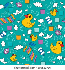 Rubber duck, shampoo, towel, paper boat among the foam and soap bubbles