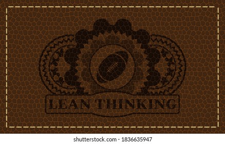 rugby ball icon and Lean Thinking text brown leather emblem. Wallet delicate background. Artistic illustration. 